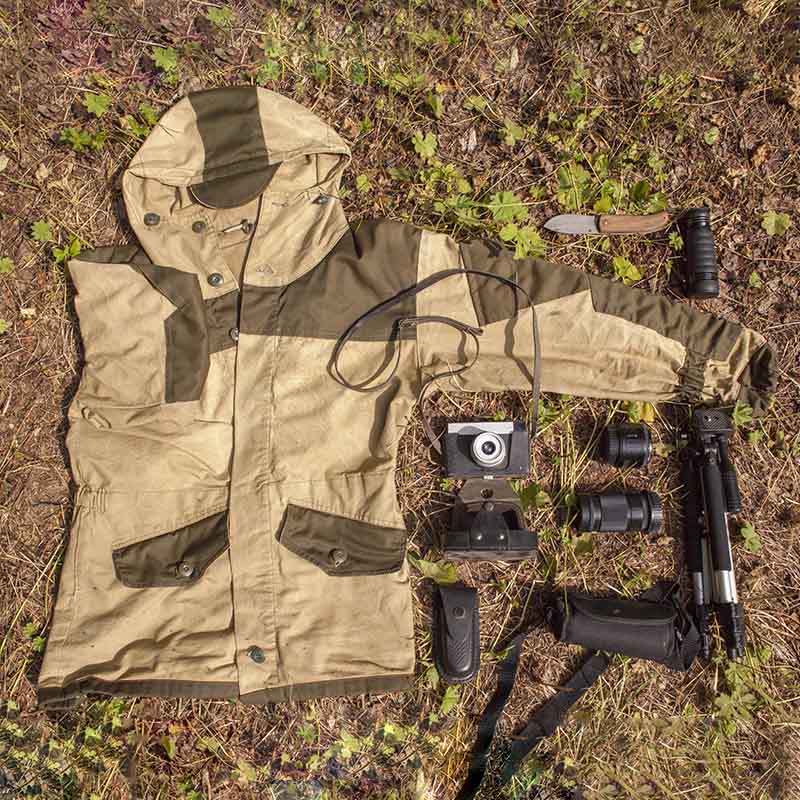 Overhead still life of camouflage anorak and photography equipment